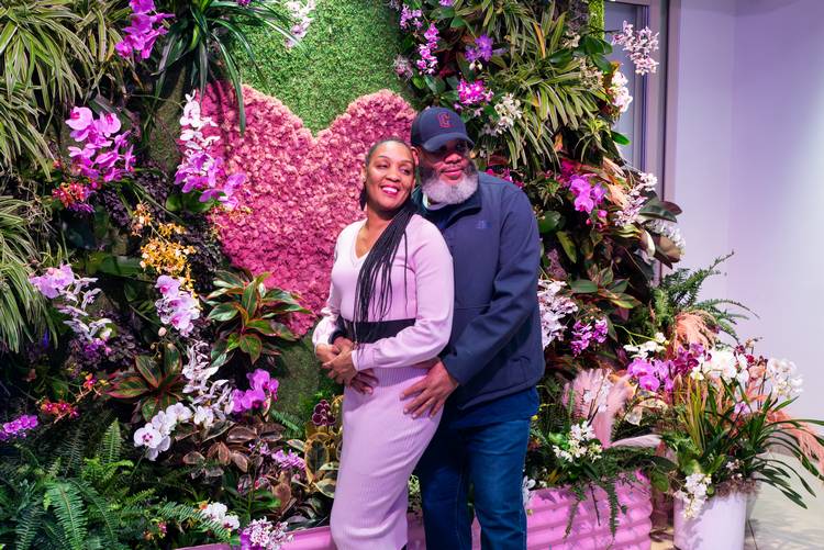 A couple poses among the orchids at a past Cleveland Botanical Garden orchid exhibit.